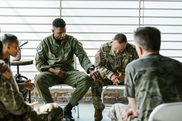 Soldiers in a supportive group therapy session focusing on mental health and recovery.