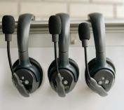 Close-up of three black headsets with microphones, ideal for audio production and communications.
